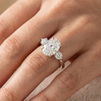 Oval cut moissanite three stone engagement ring in 14K white gold with VVS colorless center stone
