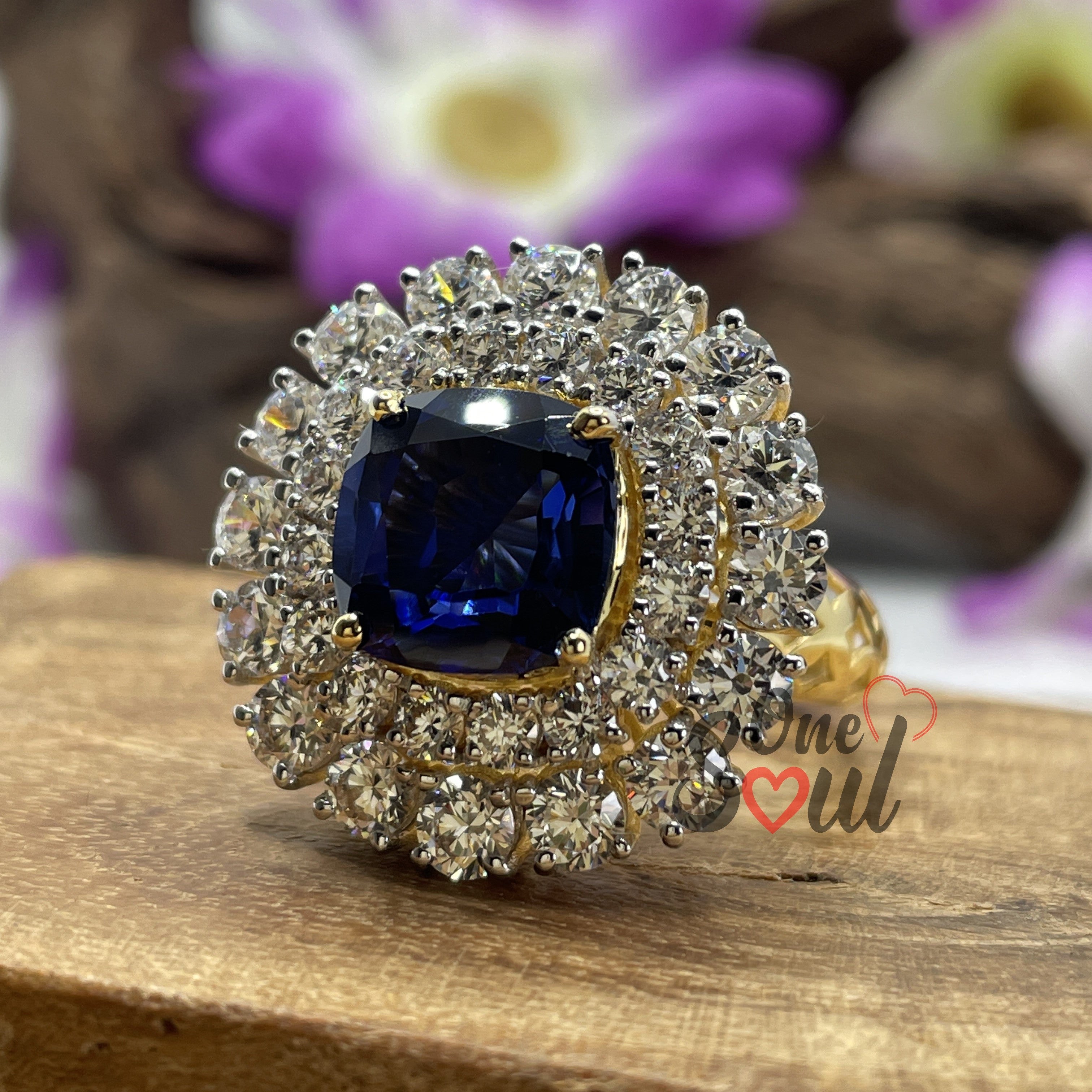 Cushion cut blue sapphire halo engagement ring with moissanite cluster in 14K yellow gold