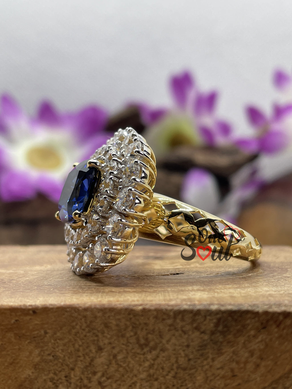 Cushion cut blue sapphire halo engagement ring with moissanite cluster in 14K yellow gold