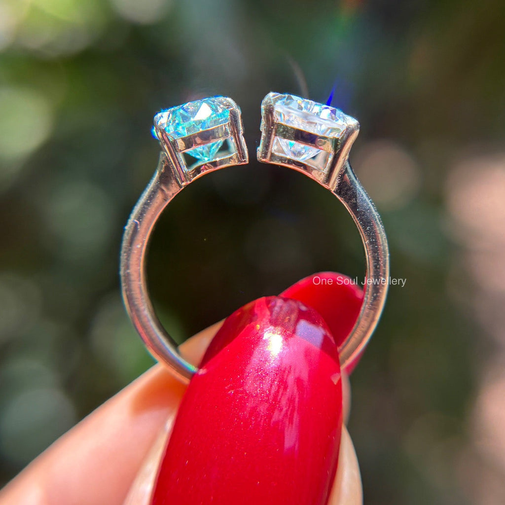 Toi et moi engagement ring with cyan blue oval moissanite and colorless pear moissanite in 14K white gold