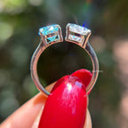 Toi et moi engagement ring with cyan blue oval moissanite and colorless pear moissanite in 14K white gold