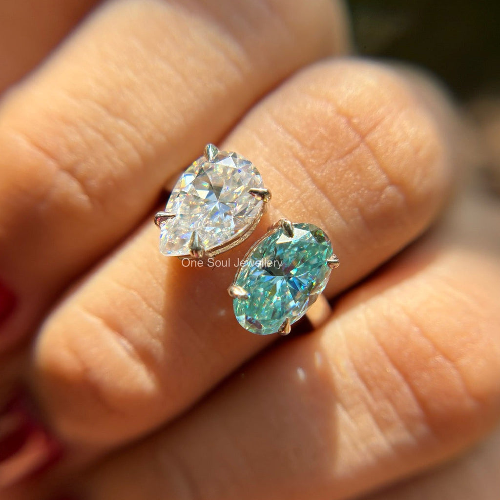 Toi et moi engagement ring with cyan blue oval moissanite and colorless pear moissanite in 14K white gold
