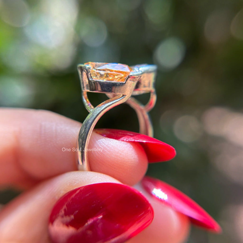 Toi et moi engagement ring with cyan blue oval moissanite and colorless pear moissanite in 14K white gold