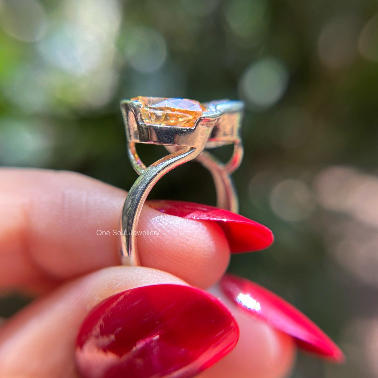 Toi et moi engagement ring with cyan blue oval moissanite and colorless pear moissanite in 14K white gold