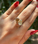 Toi et moi engagement ring with cyan blue oval moissanite and colorless pear moissanite in 14K white gold